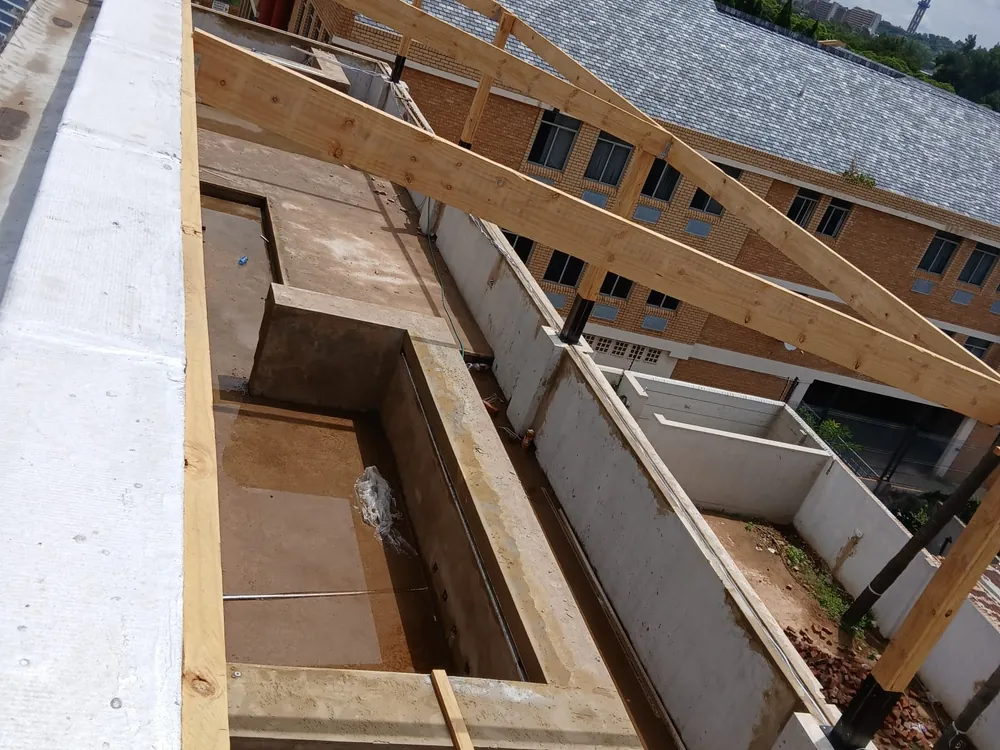 New timber framing going up over an existing structure on a Gauteng site