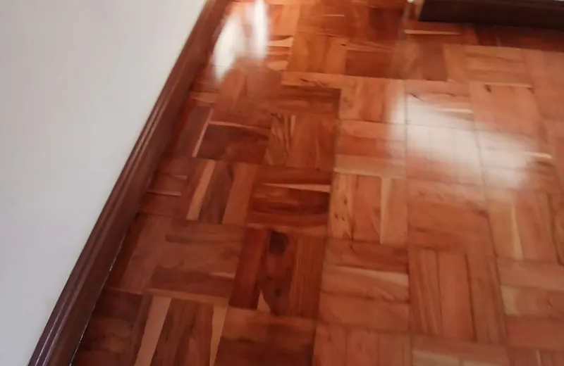 Close view of parquet blocks meeting a hardwood skirting