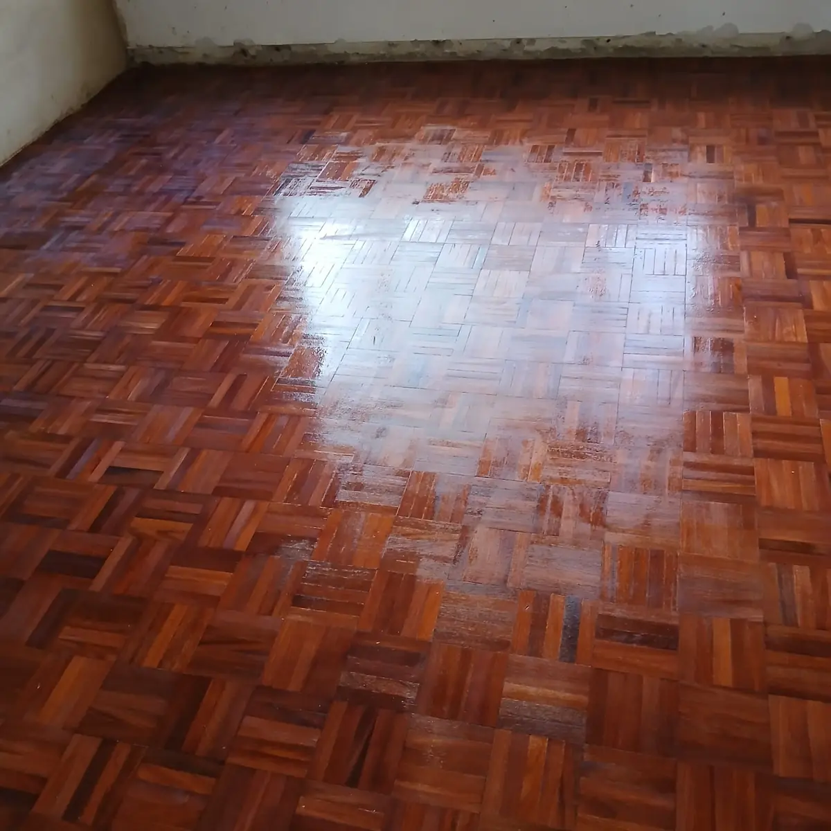 Rich red mosaic parquet flooring sanded and sealed by Impi Teak in a Midrand home