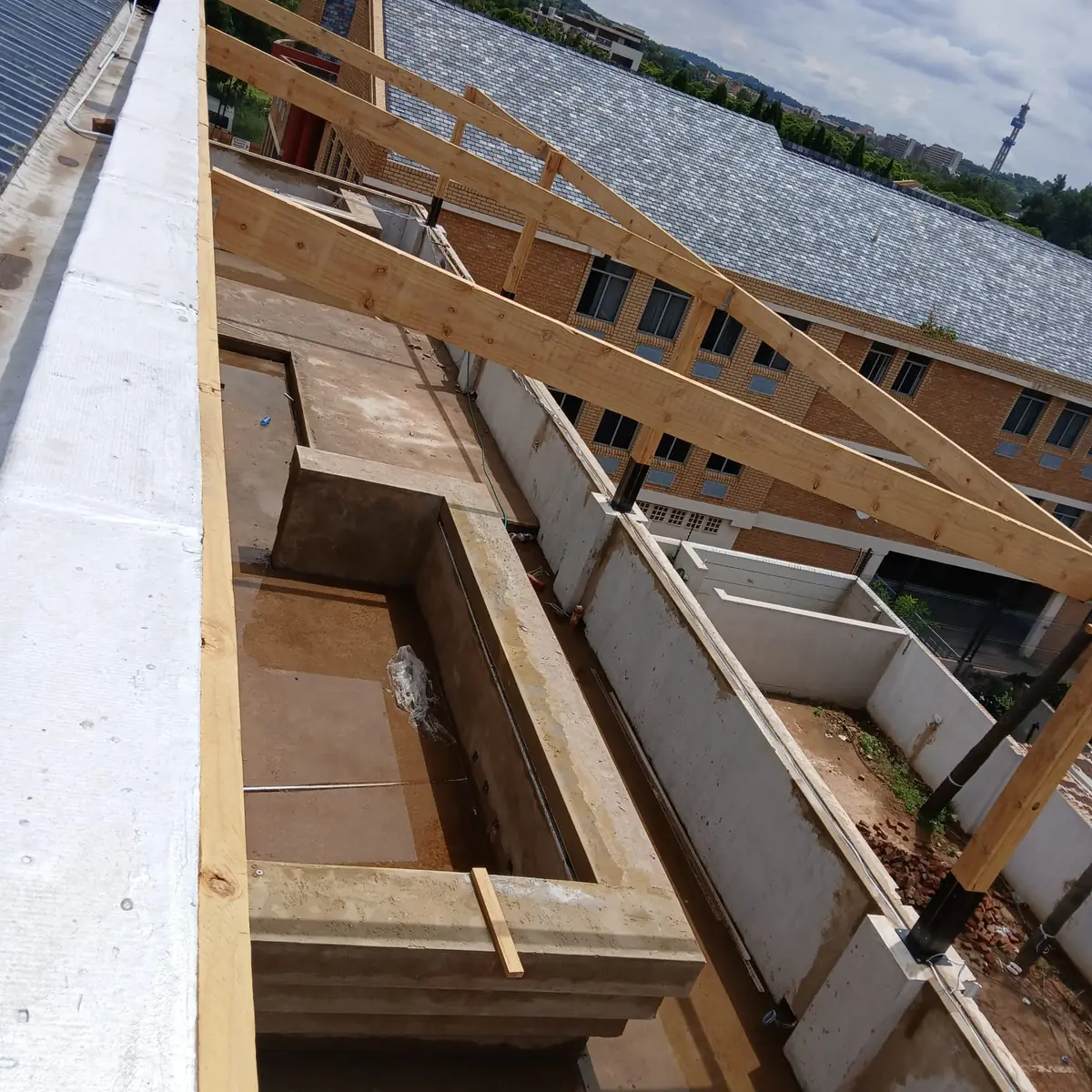 Structural timber framing going up on a Gauteng building site with Impi Teak