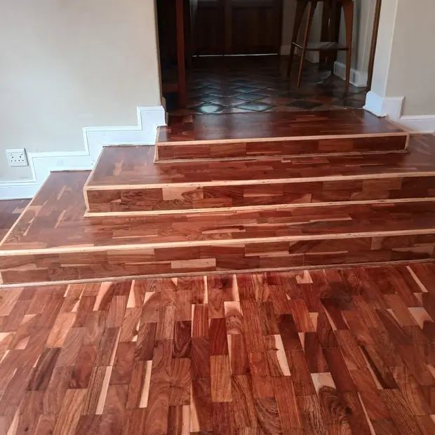 Solid hardwood flooring and built-up timber steps in a Johannesburg home by Impi Teak
