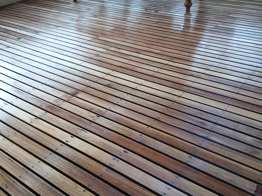 Close view of engineered hardwood boards laid over screed